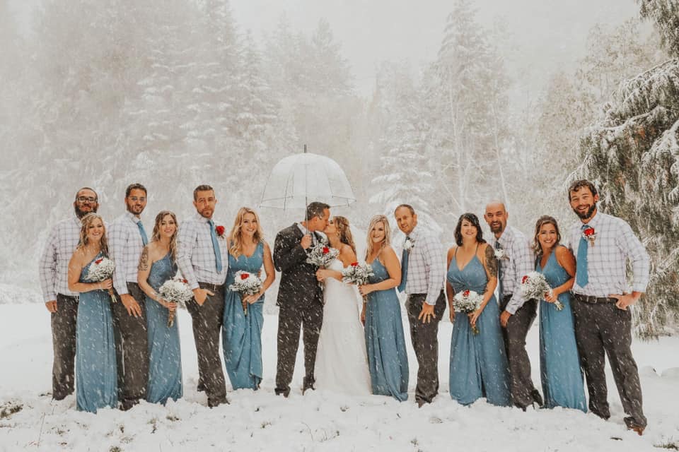 фотография пары и их друзей на фоне снежной бури